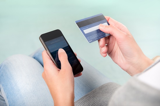 Woman verifies account balance on smartphone with mobile