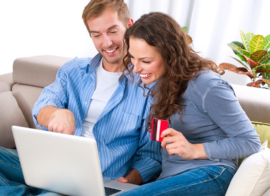 Happy Smiling Couple Using Credit Card to Shop Online